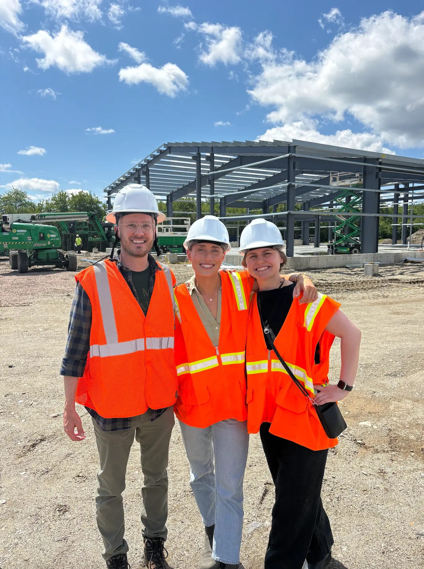 Sarah walking a construction site with company leaders